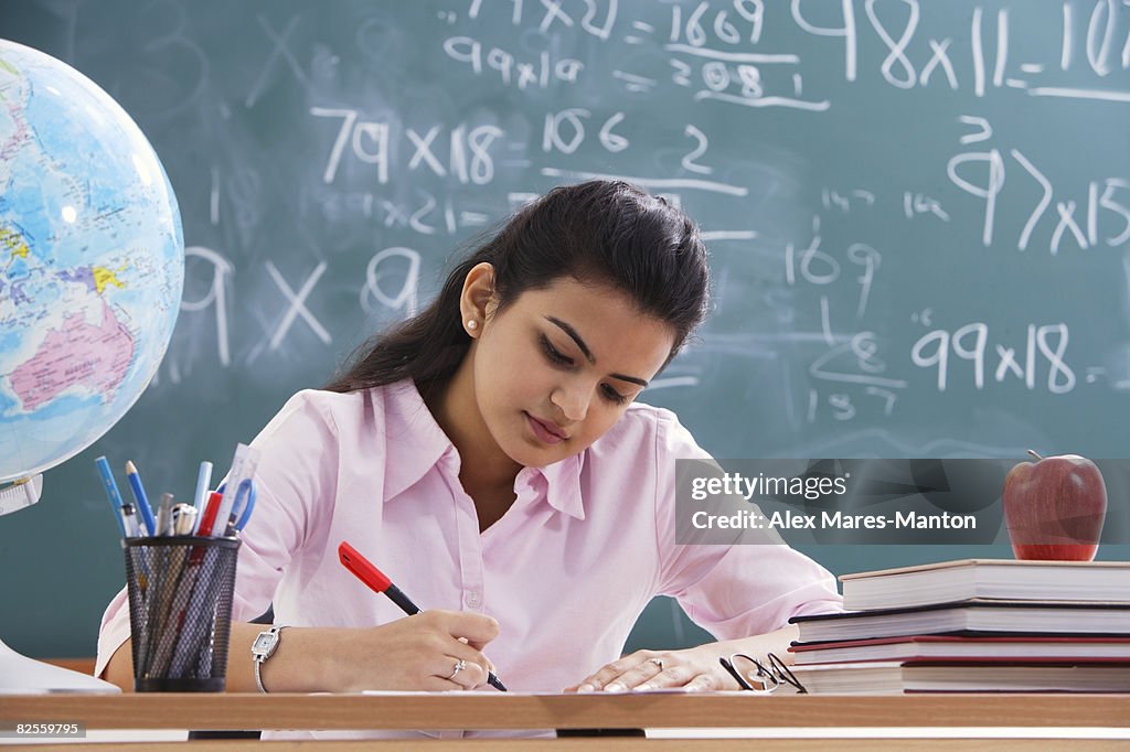 Teacher working at desk