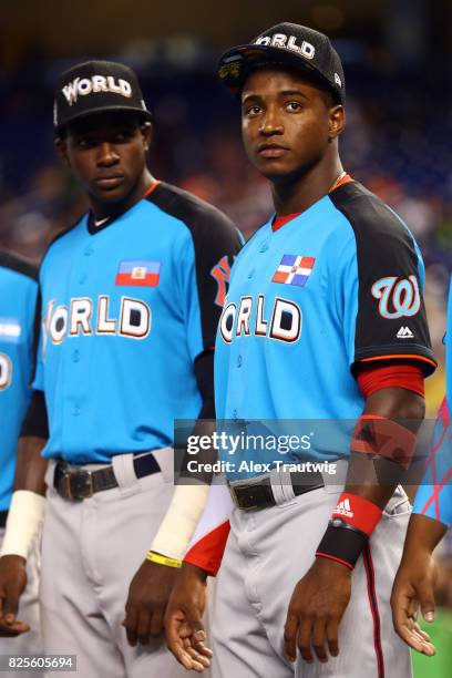 Estevan Florial and Victor Robles of the World Team look on during singing of the national anthem prior to the SirusXM All-Star Futures Game at...