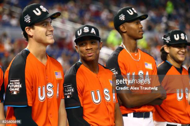Brian Anderson, Corey Ray and Triston McKenzie of Team USA look on during singing of the national anthem prior to the SirusXM All-Star Futures Game...