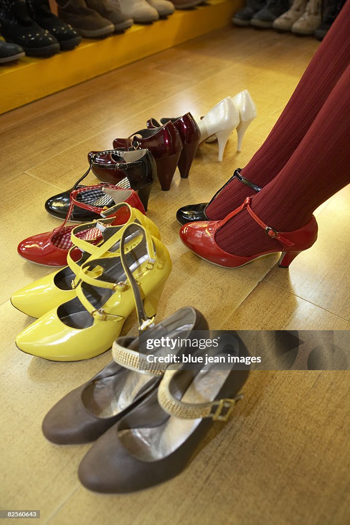 A young woman considers her choice of new shoes.