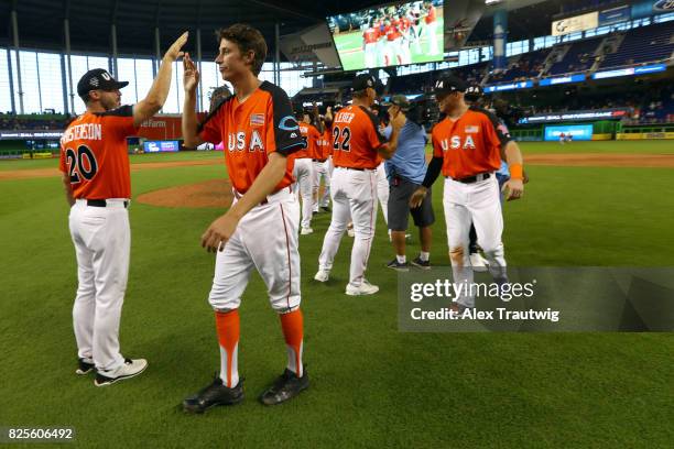 Jimmy Herget of Team USA celebrates with teammates after defeating the World Teain in the SirusXM All-Star Futures Game at Marlins Park on Sunday,...