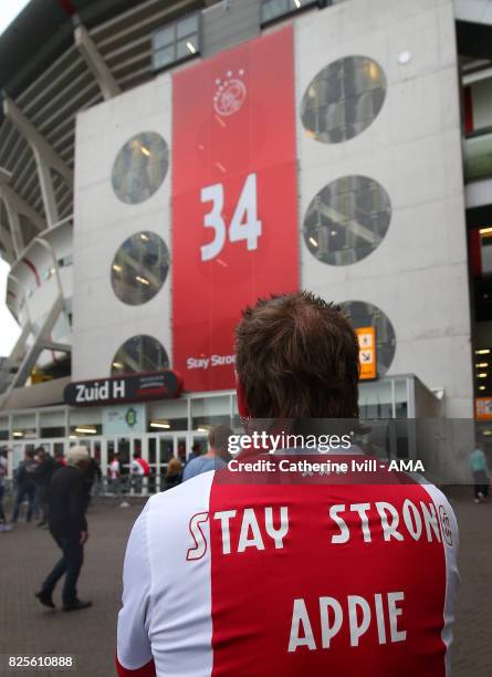 An Ajax fan wears a shirt saying stay strong Appie in support of Abdelhak Nouri of Ajax before the UEFA Champions League Qualifying Third Round match...