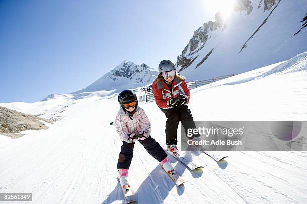 mother and daughter skiing - family winter sport stock pictures, royalty-free photos & images