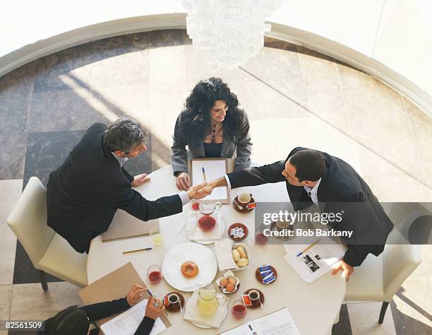 two businessmen shaking hands in meeting - breakfast meeting stock pictures, royalty-free photos & images