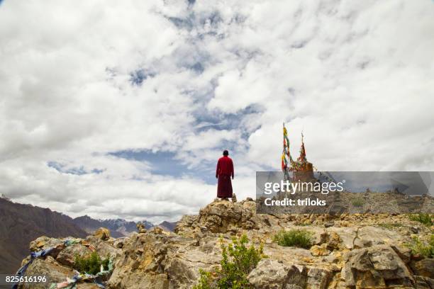 monk praying on hill - monks stock pictures, royalty-free photos & images
