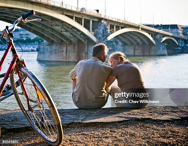 couple by riverside - budapest people stock pictures, royalty-free photos & images