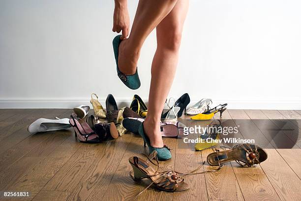 legs surrounded by shoes - women trying on shoes 個照片及圖片檔