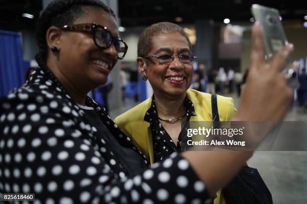 Rep. Eleanor Holmes Norton poses for a selfie with an attendee during a job fair at the Walter E. Washington Convention Center August 2, 2017 in...