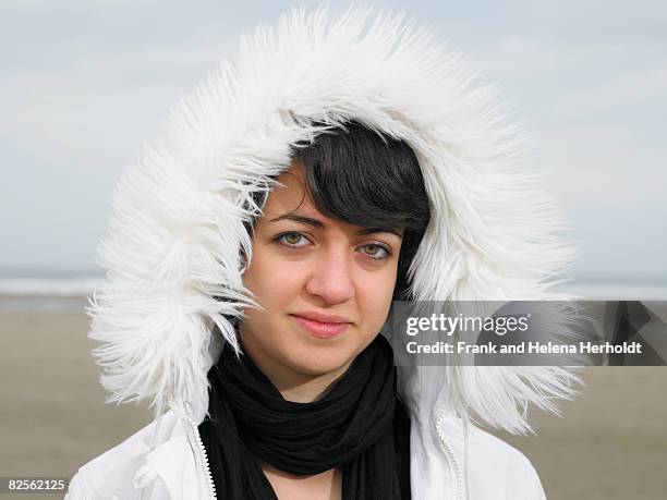 portrait of woman in white fur hood - croyde beach stock pictures, royalty-free photos & images