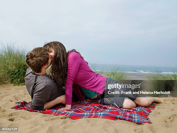 couple kissing on blanket on sand dune - croyde beach stock pictures, royalty-free photos & images