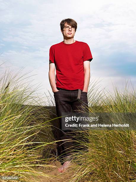 man walking through grass in sand dune - croyde beach stock pictures, royalty-free photos & images