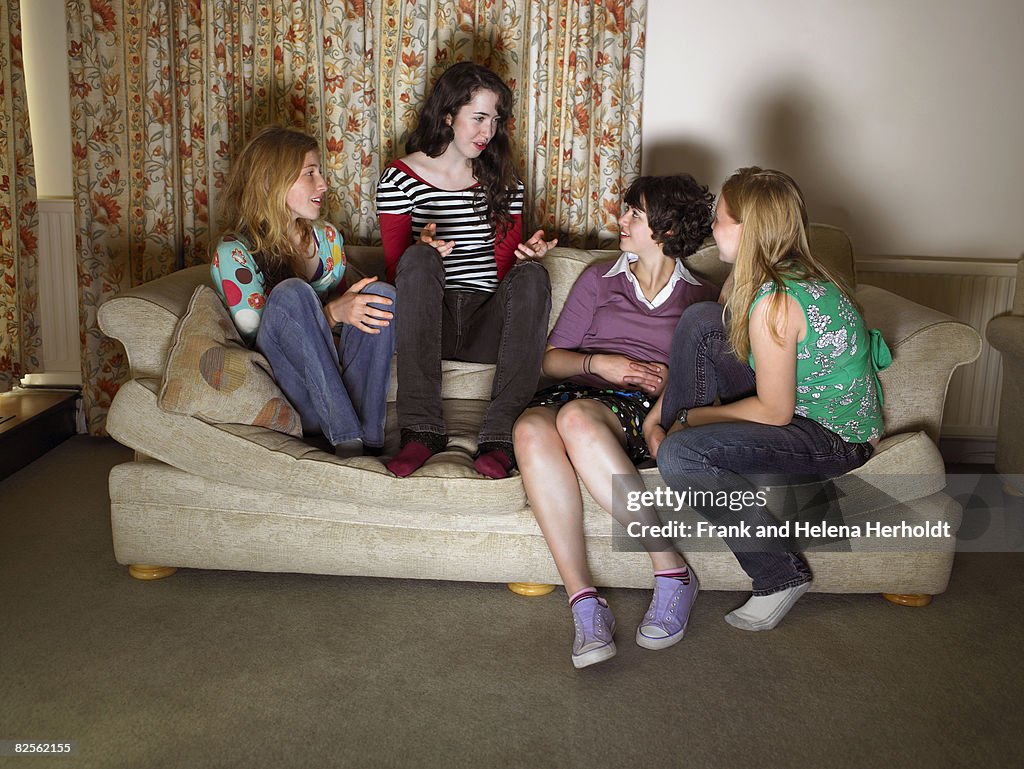 Women, sitting on sofa, gossiping