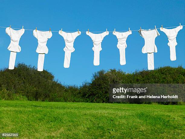 nappies hanging on washing line - croyde stock-fotos und bilder