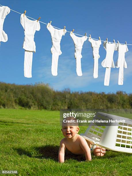baby crawling with washing basket. - croyde imagens e fotografias de stock