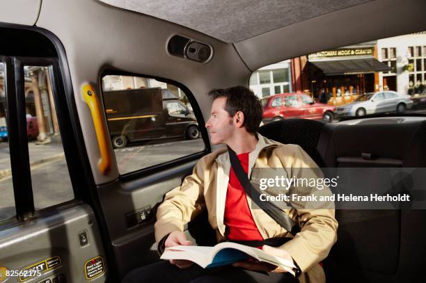 man looking out of taxi window - guidebook stock pictures, royalty-free photos & images