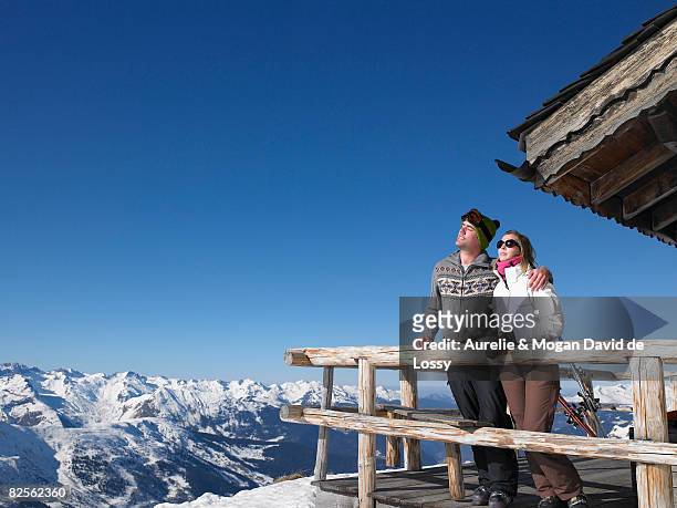 couple enjoying sun at mountains - meribel fotografías e imágenes de stock