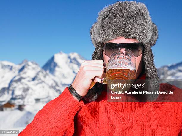young man having drink at mountains - skifahrer stock-fotos und bilder