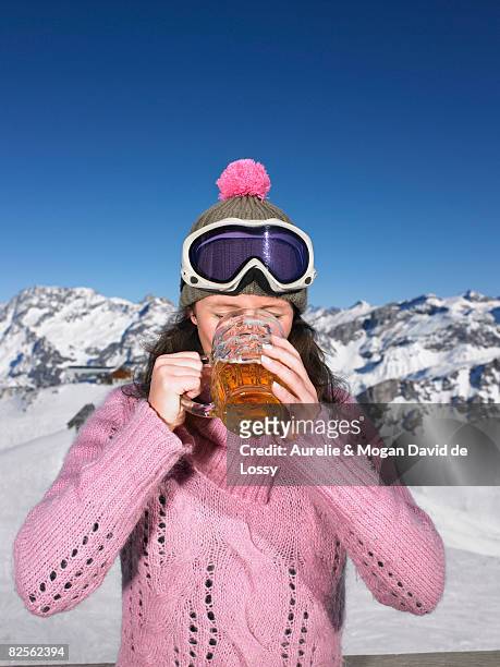 young woman having drink at mountains - beer goggles stock pictures, royalty-free photos & images