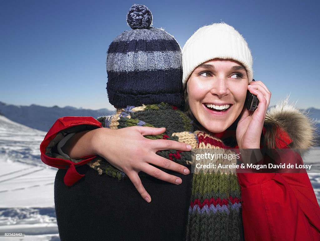 Man hugging woman on phone
