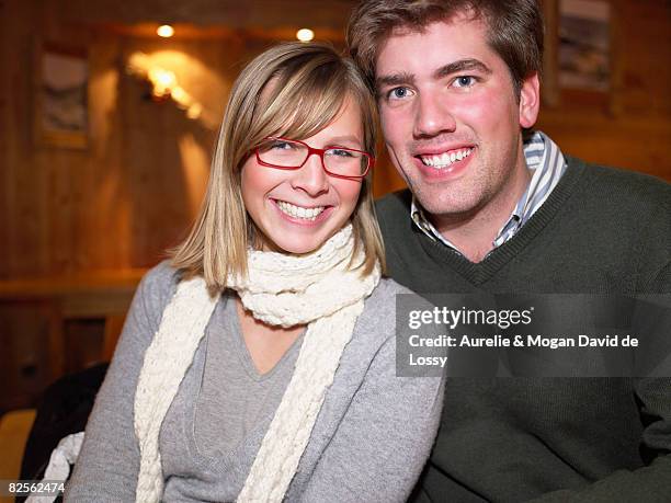 smiling couple in restaurant - meribel photos et images de collection