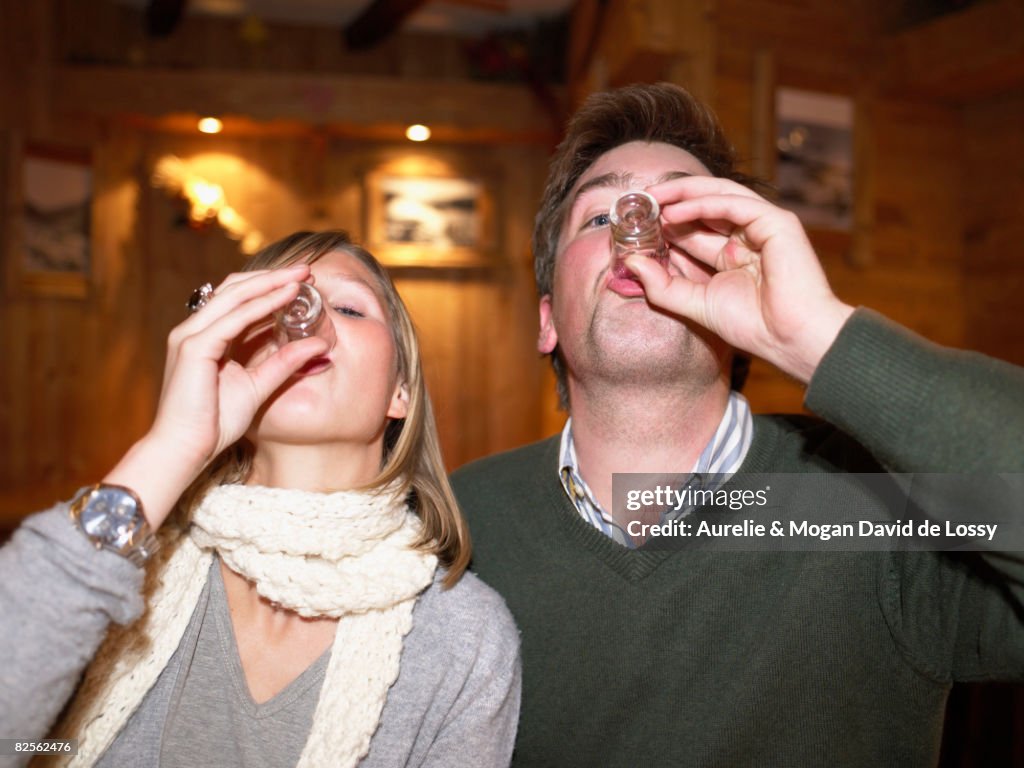 Couple having shots in restaurant