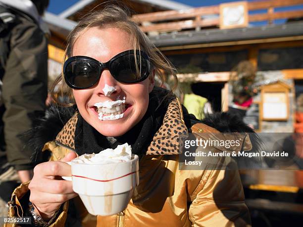 young woman with whipped cream on lips - skirestaurant stock-fotos und bilder