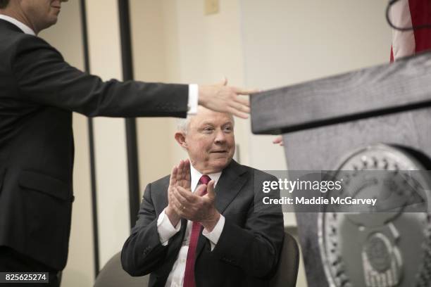 Attorney General Jeff Sessions listens to Mike DeWine, Ohio Attorney General, before speaking on the opioid epidemic at The Columbus Police Academy...