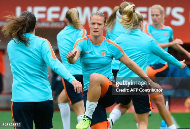 Netherlands' midfielder Sheila van den Bulk stretches as she takes a part in a training session with teammates in Enschede on August 2 on the eve of...