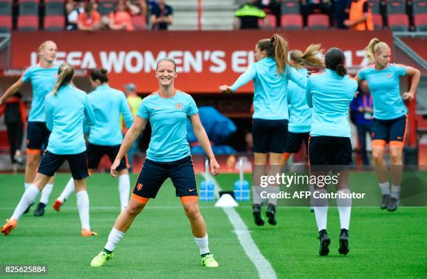 Netherlands' midfielder Sheila van den Bulk stretches as she takes a part in a training session with teammates in Enschede on August 2 on the eve of...