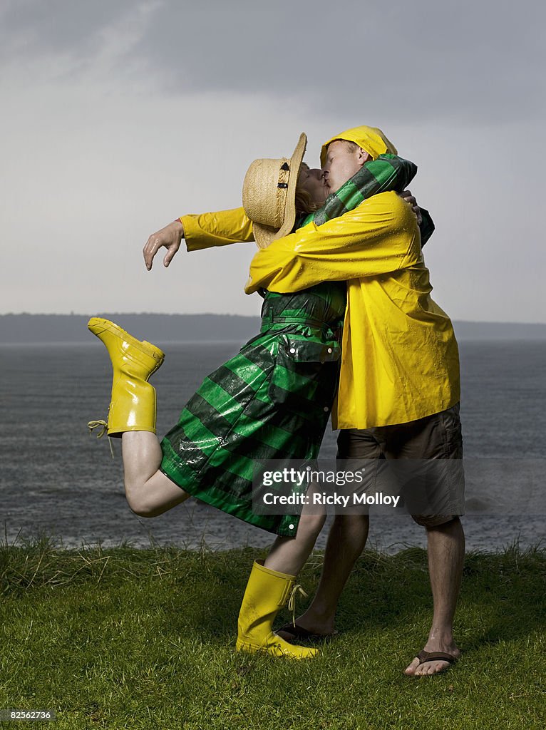 Couple kissing and hugging in the rain