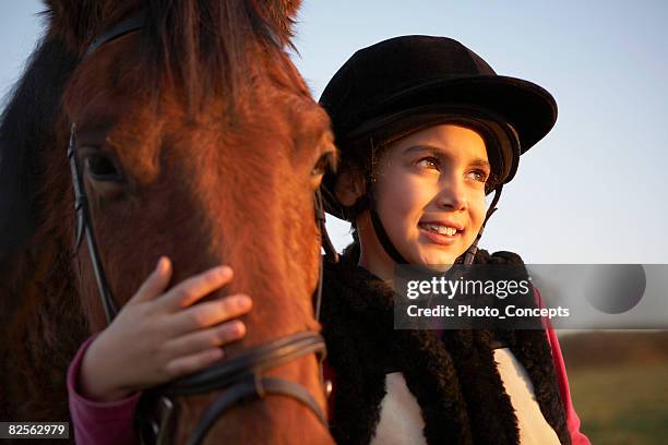 chica abrazándose pony - riding hat fotografías e imágenes de stock