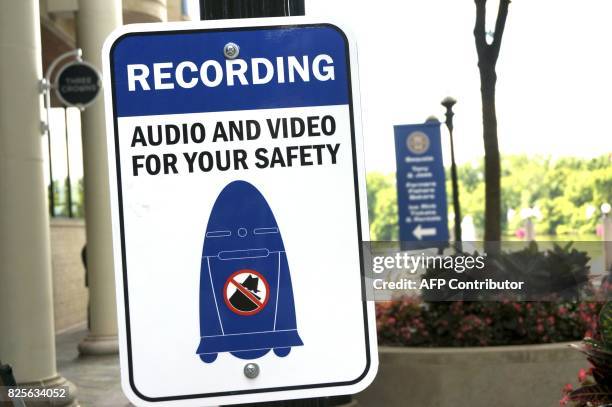 Sign informs the public about a five-foot tall outdoor K5 security robot patroling the grounds of the Washington Harbour retail-residential center in...