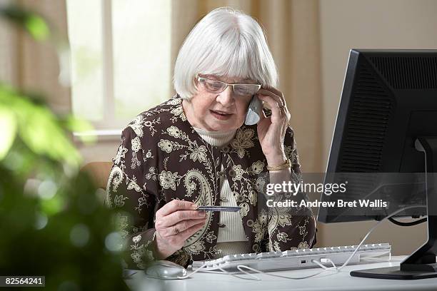 elderly woman using credit card over the phone - silver surfer stock pictures, royalty-free photos & images