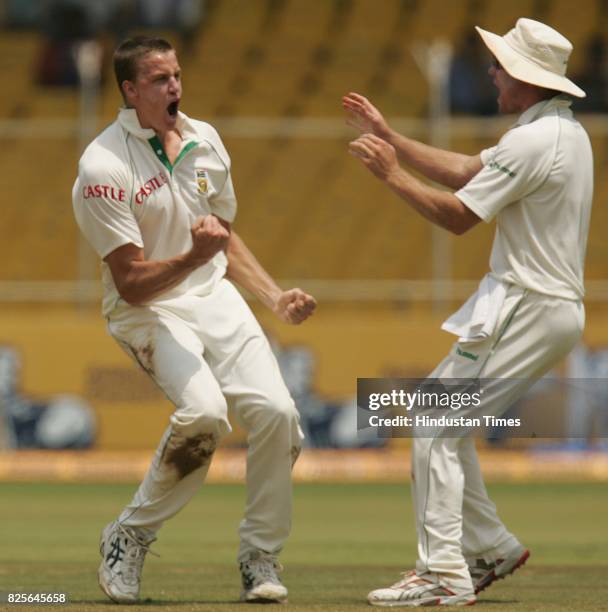 Cricket - India vs South Africa Second Test Match at Ahmedabad - South Africa bowler Morney Morkel celebraes with his teammates the wicket of India's...