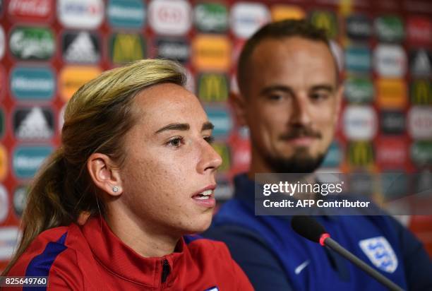 England's midfielder Jordan Nobbs is watched by England's head coach Mark Sampson as she addresses a press conference before a training session in...