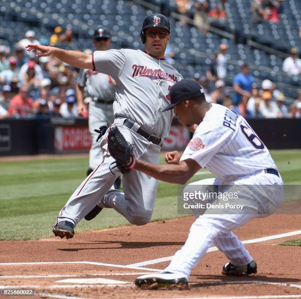 Joe Mauer of the Minnesota Twins is tagged out at the plate by Luis Perdomo of the San Diego Padres during the first inning of a baseball game at...