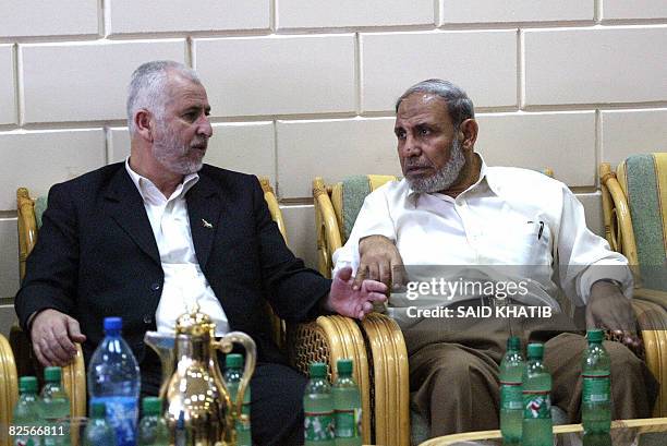 Palestinian senior Hamas official Mahmud Zahar and former interior minister Said Siam sit waiting to cross at the Rafah border terminal crossing...