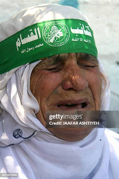 The mother of killed Palestinian Hamas member, Mahmud Assi, wears the green headband of the Islamist groups's armed wing, the Ezzedine Al-Qassam...