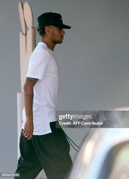 Brazilian football player Neymar is pictured upon his arrival at Francisco Sa Carneiro airport on the outskirts of Porto, during a stop over from...
