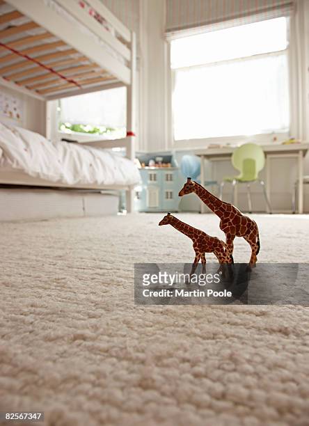 two toy giraffes on childrens bedroom floor - carpet stock pictures, royalty-free photos & images