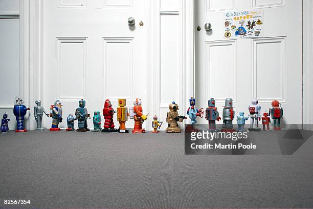 toy robots lined up outside childs bedroom - concepts & topics stock pictures, royalty-free photos & images