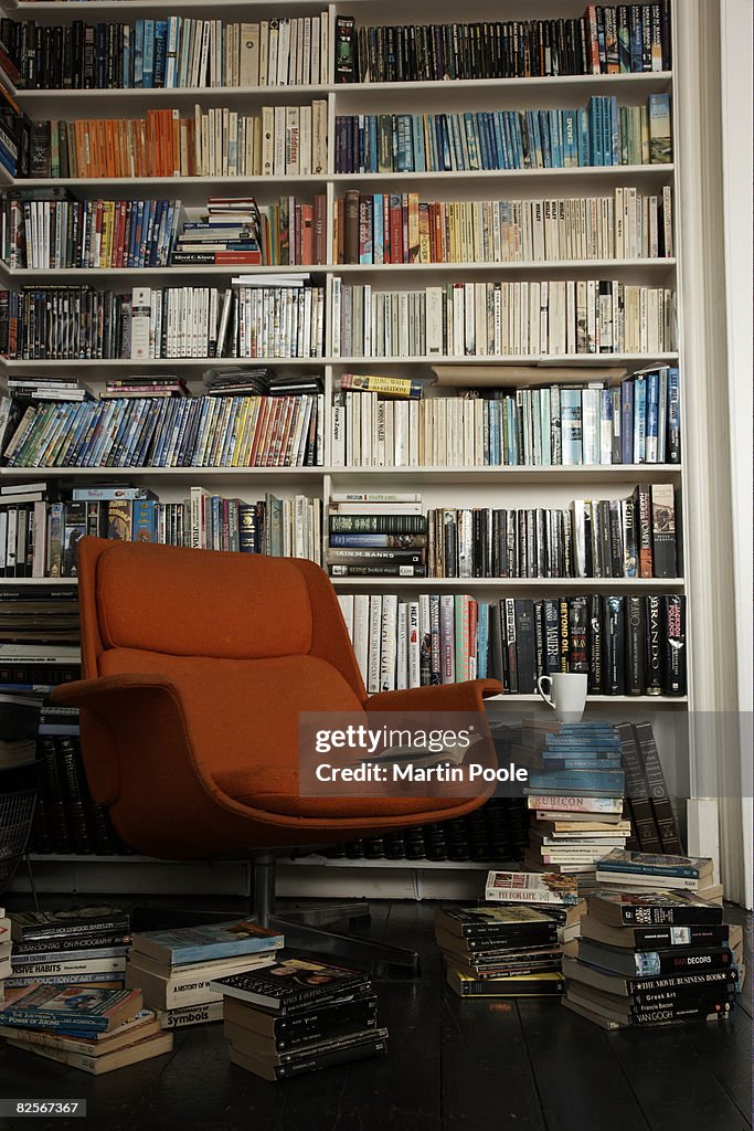 Comfortable chair surrounded by books