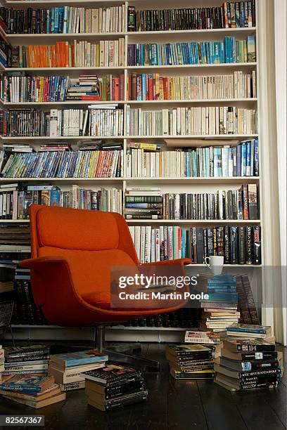 comfortable chair surrounded by books - collection stock pictures, royalty-free photos & images