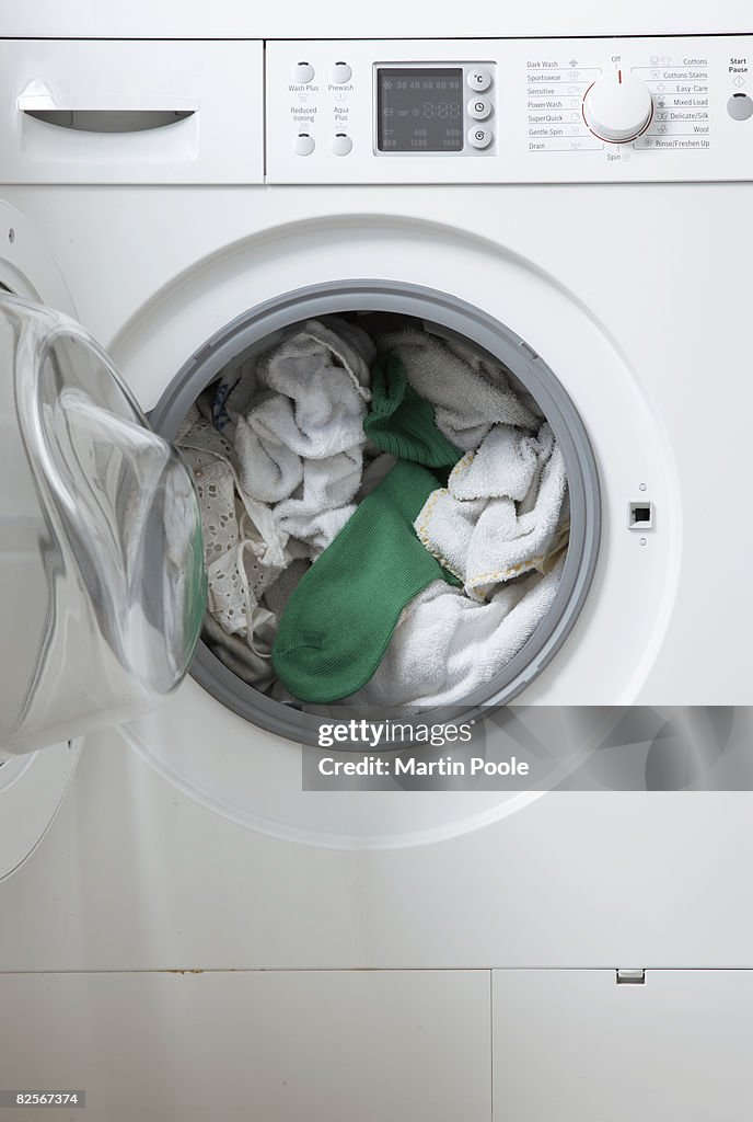 White washing in machine one green sock