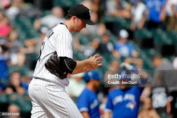 Jake Petricka of the Chicago White Sox reacts after throwing a wild pitch, allowing the Toronto Blue Jays to score, a run during the eighth inning at...
