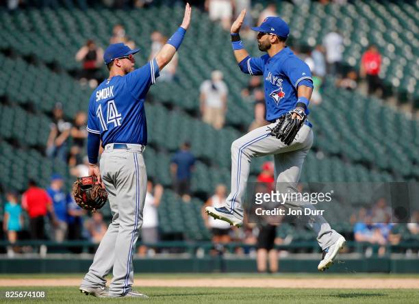 Justin Smoak of the Toronto Blue Jays and Jose Bautista celebrate their win over the Chicago White Sox at Guaranteed Rate Field on August 2, 2017 in...