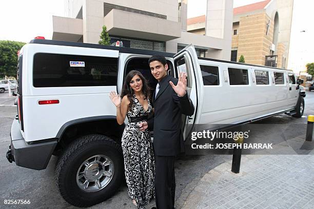 Lebanese student Rami Dakkash and his prom date Elissa al-Murr wave as they get into a rented Hummer limousine before going to their prom party in...