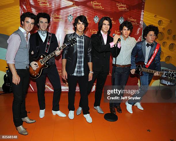 Kevin Jonas, Joe Jonas and Nick Jonas of The Jonas Brothers at the unveiling of wax figures at Madam Tussauds on August 18, 2008 in Washington, DC.