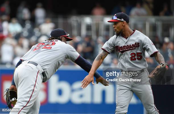 Miguel Sano of the Minnesota Twins, left, and Byron Buxton celebrate after beating the San Diego Padres 5-2 in a baseball game at PETCO Park on...
