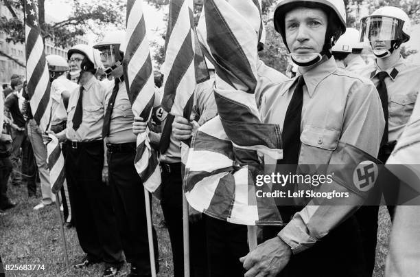 View of members of the American Nazi Party, in helmets and uniforms, as they demonstrate outside the White House, Washington DC, July 3, 1976. Their...